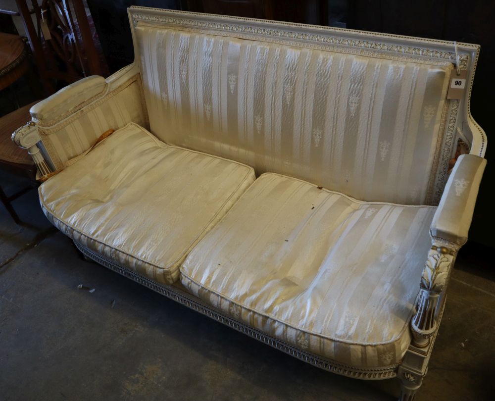 An early 20th century parcel gilt white painted canapé, width 128cm